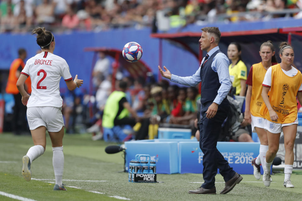 England head coach Philip Neville passes the ball to England's Lucy Bronze, left, during the Women's World Cup round of 16 soccer match between England and Cameroon at the Stade du Hainaut stadium in Valenciennes, France, Sunday, June 23, 2019. (AP Photo/Michel Spingler)