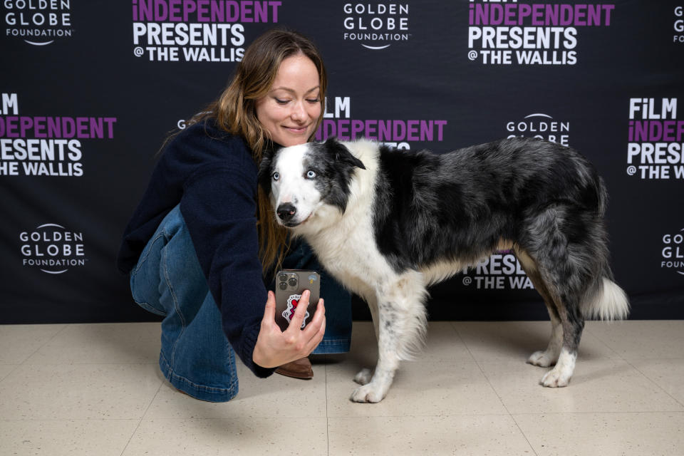 Olivia Wilde taking a selfie with Messi the dog