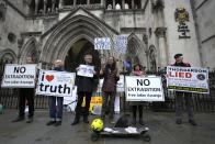 Demonstrators hold banners as supporters of Julian Assange stage a demonstration outside the High Court in London, Wednesday, Oct. 27, 2021. The U.S. government is scheduled to ask Britain's High Court to overturn a judge's decision that WikiLeaks founder Julian Assange should not be sent to the United States to face espionage charges. A lower court judge refused extradition in January on health grounds, saying Assange was likely to kill himself if held under harsh U.S. prison conditions. (AP Photo/Kirsty Wigglesworth)