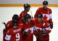 Canada's Jamie Benn (22) celebrates with teammates Patrick Marleau (C), Sidney Crosby (R), Jonathan Toews (16) and Matt Duchene after their win over Team USA at the conclusion of the men's ice hockey semi-final game at the 2014 Sochi Winter Olympic Games, February 21, 2014. REUTERS/Brian Snyder