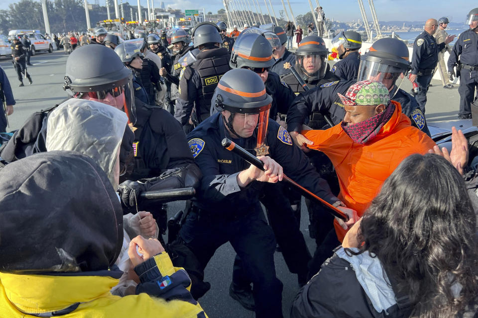 FILE - Demonstrators clash with police as arrests are made after shutting down the San Francisco Oakland Bay Bridge in conjunction with the APEC Summit taking place Thursday, Nov. 16, 2023, in San Francisco. San Francisco's District Attorney's Office on Monday began charging demonstrators who blocked traffic for hours last month on the Bay Bridge to demand a cease-fire in Gaza.(AP Photo/Noah Berger, File)