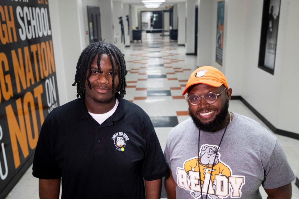 Rodrick Collins, a Fairley High School senior who was shot on his way home from school just days after asking Principal Julius Blackburn for help finding a tuxedo for prom, poses for a portrait with Blackburn in a hallway at the school in Memphis, Tenn., on Monday, May 20, 2024. Collins recovered in time to make it to prom in a tuxedo purchased with help from Blackburn.