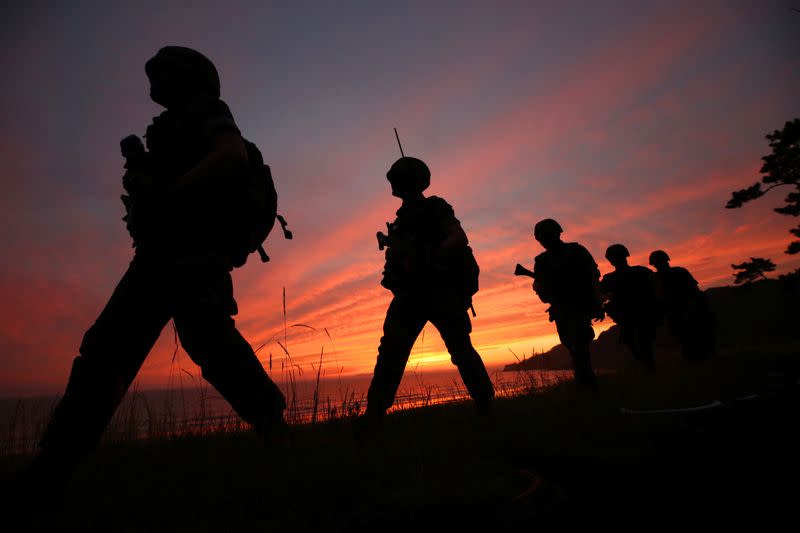 Members of South Korean marine corps patrol during sunset in Yeonpyeong island