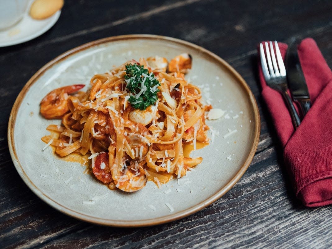 Tagliatelle with seafood on plate at restaurant