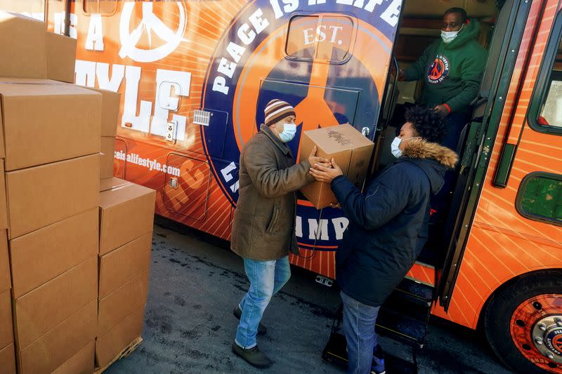 Workers stack boxes of food distributed by the charity Lifecamp in New York City