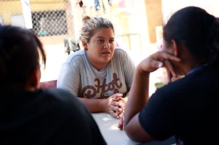 Honduran migrant Denia Carranza, 24, who has given up her U.S. asylum claim under the Migrant Protection Protocol (MPP), talks with fellow migrants at Casa del Migrante migrant shelter, in Ciudad Juarez