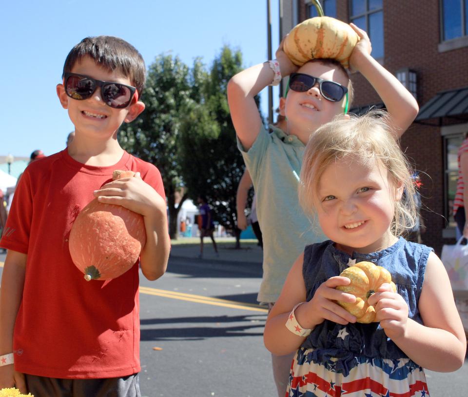 Parker Owen, Parker Hill and Hadleigh Hill pick out pumpkins at the 2019 Gallatin Main Street Festival. This year's event features more than 200 vendors and food trucks.