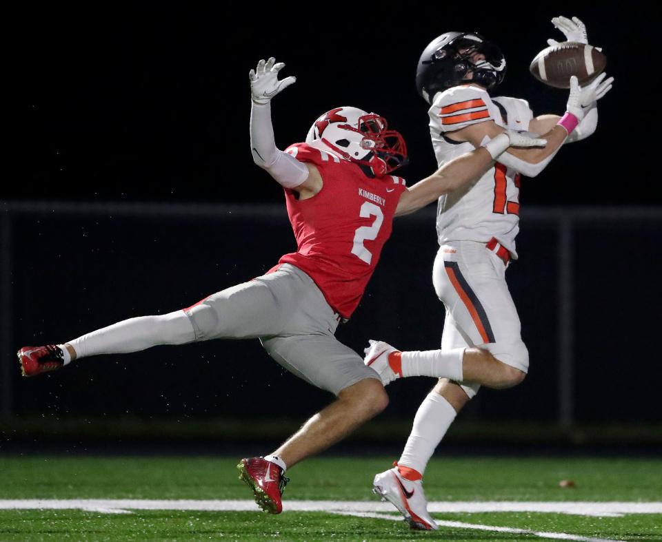 Kaukauna's Parker Schuh (13) catches a pass against Kimberly's Ty Lotten (2) during their football game Oct. 14 in Kimberly.