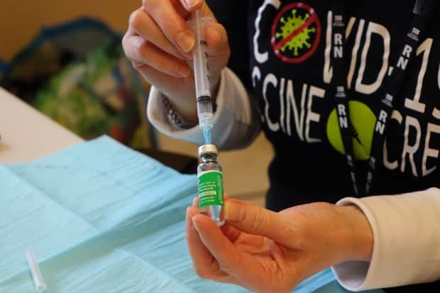 Registered nurse Joyce Kelly prepares a dose of the AstraZeneca-Oxford COVID-19 vaccine at the clinic on Mundy Pond Road in St. John's on March 19. (Patrick Butler/Radio-Canada - image credit)