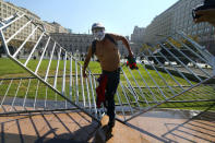 A demonstrator wears a Guy Fawkes mask as he walks on fences in front of the government house during a protest calling for changes in the education system in Santiago, Chile April 11, 2017. REUTERS/Ivan Alvarado