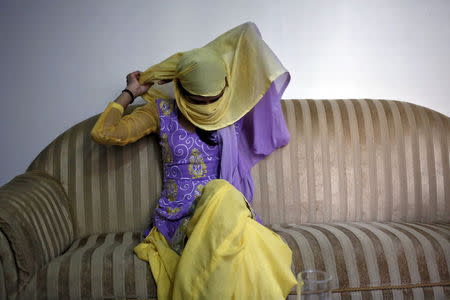 Meenakshi Kumari, 23, one of the two sisters allegedly threatened with rape by a village council in Uttar Pradesh, adjusts her headgear as she sits inside her lawyer's chamber in New Delhi, India, September 1, 2015. REUTERS/Anindito Mukherjee