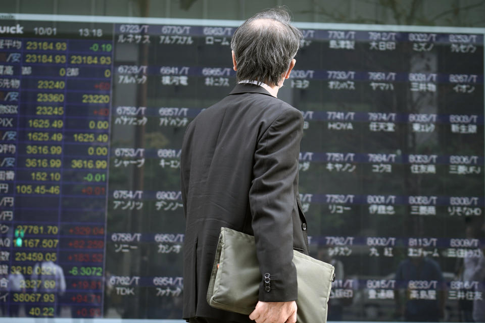 A man looks at an electronic stock board supposedly showing Japan's Nikkei 225 index at a securities firm Thursday, Oct. 1, 2020, in Tokyo. Trading on the Tokyo Stock Exchange was suspended Thursday because of a problem in the system for relaying market information. Most other Asian markets were closed for national holidays. (AP Photo/Eugene Hoshiko)