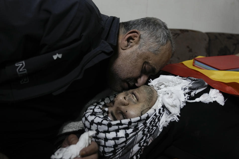 A relative mourns Mohammed Sherif Hassan Selmi during his funeral in Qalqiliya, West Bank, Tuesday, Feb. 13, 2024. The Israeli army said that Salemi was shot and killed when he tried to overrun soldiers. (AP Photo/Majdi Mohammed)