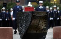 New York City firefighters from Engine 54, Ladder 4, Battalion 9, stand during a moment of silence at a ceremony in a park dedicated to honoring members of the firehouse on West 48th Street who lost their lives in the September 11, 2001 attacks on the World Trade Center on the 12th anniversary of the attacks, in New York, September 11, 2013. 15 fire fighters from Engine 54, Ladder 4, Battalion 9 died in the 9/11 attacks, the most of any fire company in New York. (REUTERS/Mike Segar)