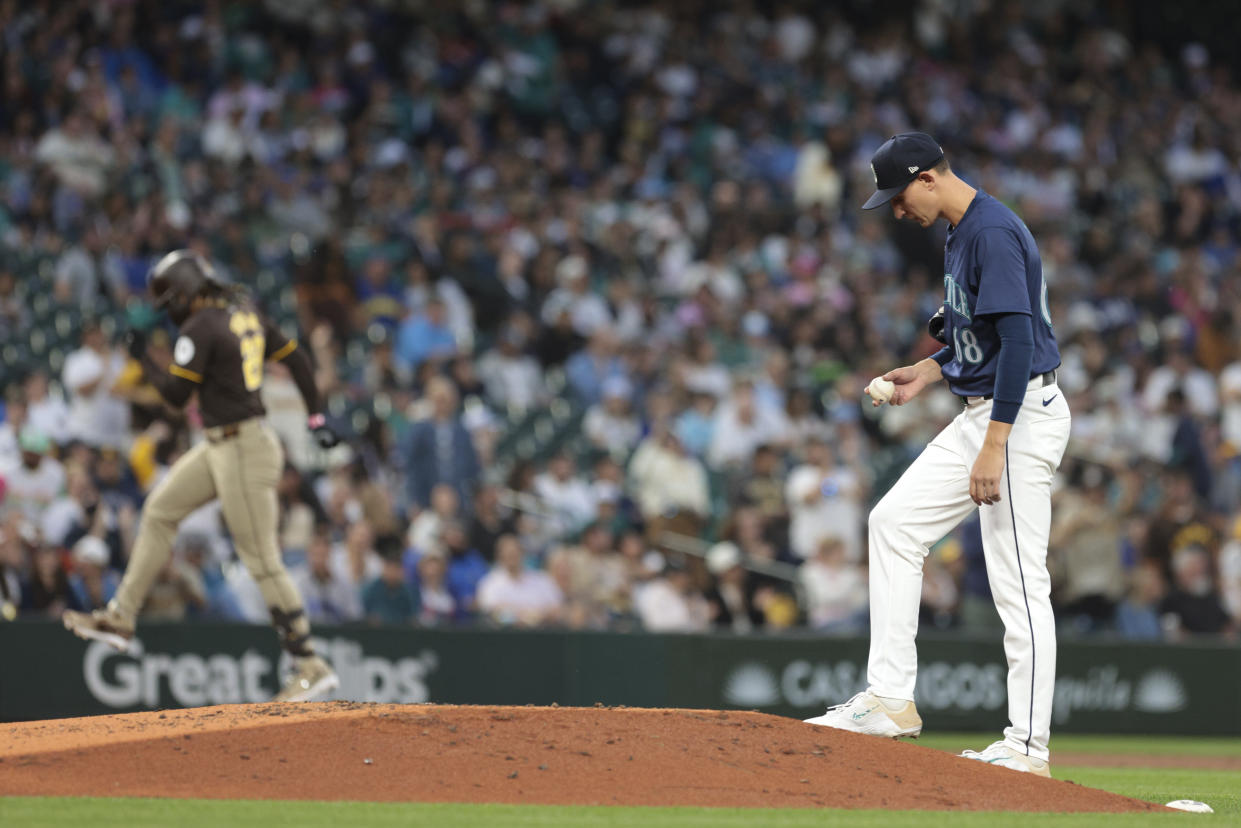 Seattle Mariners starting pitcher George Kirby, right, looks on as San Diego Padres' Fernando Tatis Jr. rounds third base after hitting a three-run home run during the third inning of a baseball game, Tuesday, Sept. 10, 2024, in Seattle. (AP Photo/Jason Redmond)