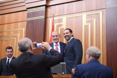 Lebanon's Finance Minister Ali Hassan Khalil takes photos of the parliamentary re-elected speaker Nabih Berri with outgoing Prime Minister Saad al-Hariri at the parliament in Beirut, Lebanon May 23, 2018. Lebanese Parliament/Handout via REUTERS