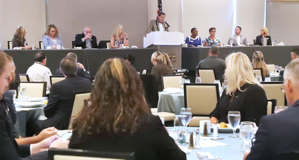 An audience of business leaders and local elected officials listens to Bob Davis, president and CEO of the Lodging & Hospitality Association of Volusia County, at a National Tourism Week celebration on Wednesday at Hard Rock Hotel.