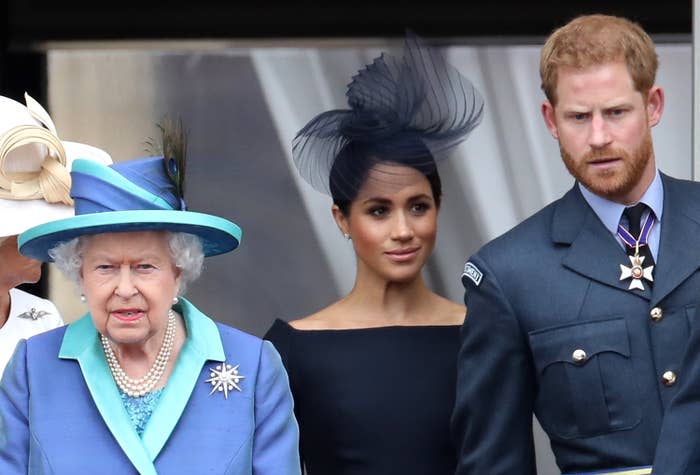 Meghan and Harry stand next to the queen