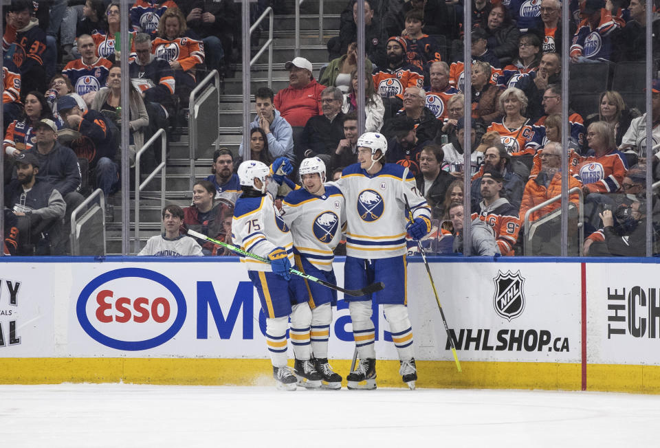 Buffalo Sabres' Connor Clifton (75), JJ Peterka (77) and Tage Thompson (72) celebrate after a goal against the Edmonton Oilers during second-period NHL hockey game action in Edmonton, Alberta, Thursday March 21, 2024. (Jason Franson/The Canadian Press via AP)