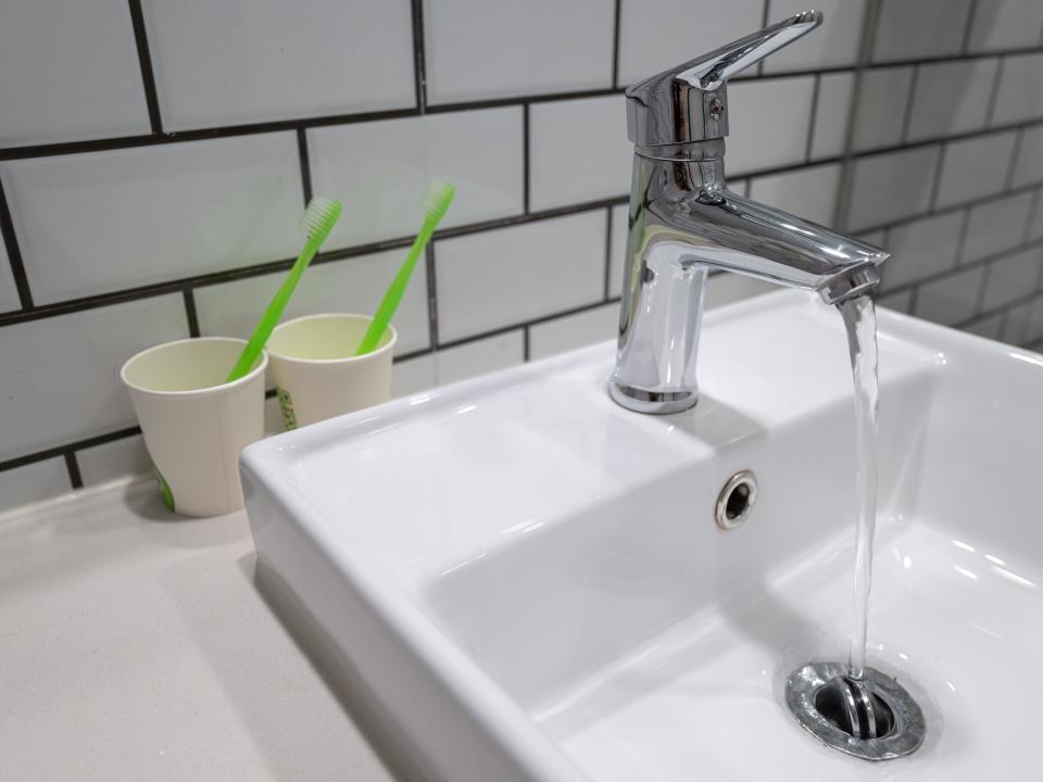 Bathroom sink with toothbrushes