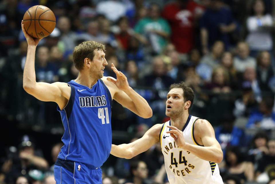 Dallas Mavericks forward Dirk Nowitzki (41) looks to pass as Indiana Pacers forward Bojan Bogdanovic (44) defends during the first half of an NBA basketball game, Monday, Feb. 26, 2018, in Dallas. (AP Photo/Ron Jenkins)