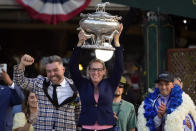 FILE - Trainer Jena Antonucci, center, hoists up the August Belmont Trophy alongside jockey Javier Castellano, right, and owner Jon Ebbert, left, after their horse Arcangelo won the 155th running of the Belmont Stakes horse race, Saturday, June 10, 2023, at Belmont Park in Elmont, N.Y. Kentucky Derby winner Mage and Belmont Stakes winner Arcangelo head a full field of 14 horses for the wide-open Breeders' Cup Classic. (AP Photo/Seth Wenig, File)