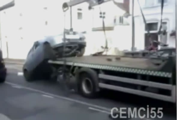 Motorist drives car off lorry