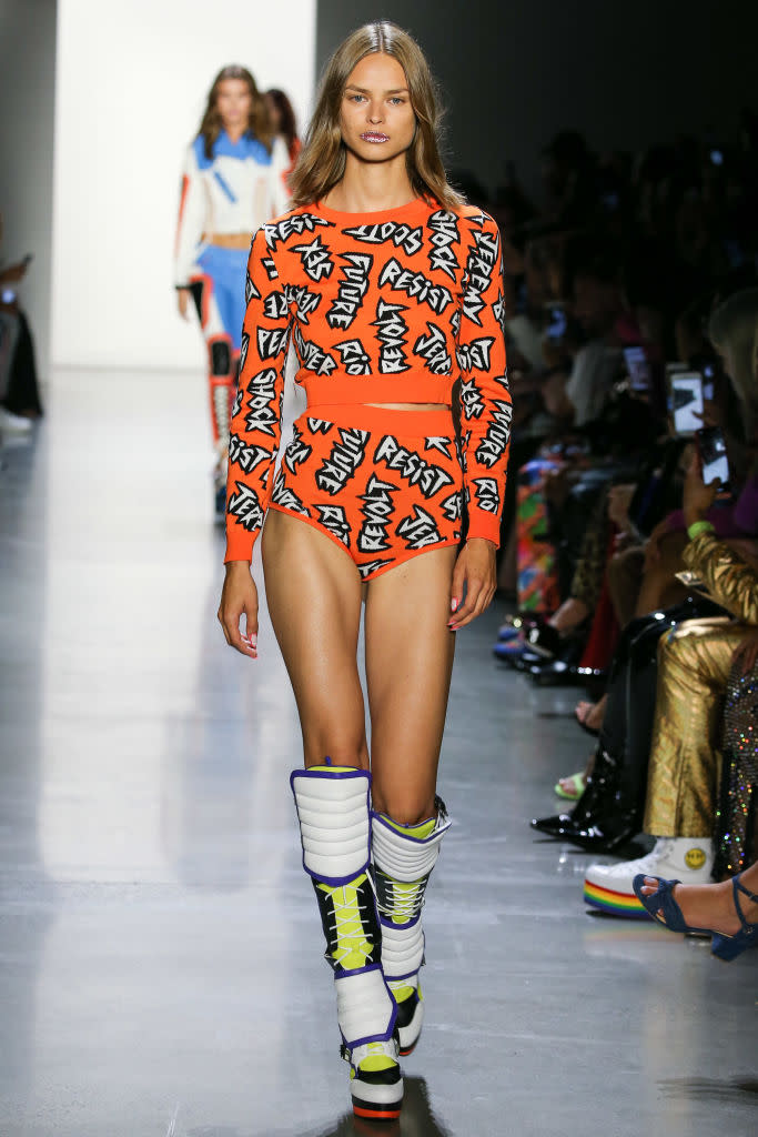 <p>At Jeremy Scott’s Spring 2019 show, models wore sweaters, jackets, bodysuits, and more emblazoned with action words like “Riot, “Resist,” and “Shock.” (Photo: Getty) </p>