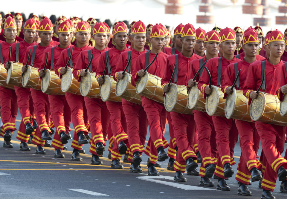 Drummers march as Thailand's King Maha Vajiralongkorn is carried on a palanquin through the streets outside the Grand Palace for the public to pay homage during the second day of his coronation ceremony in Bangkok, Sunday, May 5, 2019. Vajiralongkorn was officially crowned Saturday amid the splendor of the country's Grand Palace, taking the central role in an elaborate centuries-old royal ceremony that was last held almost seven decades ago. (AP Photo/Wason Wanichorn)