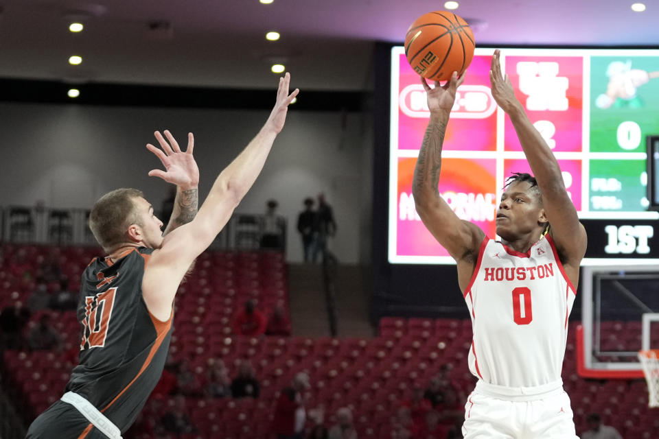 Houston guard Marcus Sasser (0) shoots a three point basket as Montana Tech forward Caleb Bellach defends during the first half of an exhibition NCAA college basketball game, Saturday, Nov. 6, 2021, in Houston. (AP Photo/Eric Christian Smith)