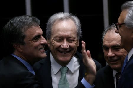 President of Brazil's Supreme Court, Ricardo Lewandowski (C) reacts near Suspended Brazilian President Dilma Rousseff's attorney in the impeachment proceedings, Jose Eduardo Cardozo (L) and Senator Raimundo Lira (2nd R), president of a special senate committee that will consider her impeachment, during a final session of debate and voting on suspended Rousseff's impeachment trial in Brasilia, Brazil, August 25, 2016. REUTERS/Ueslei Marcelino