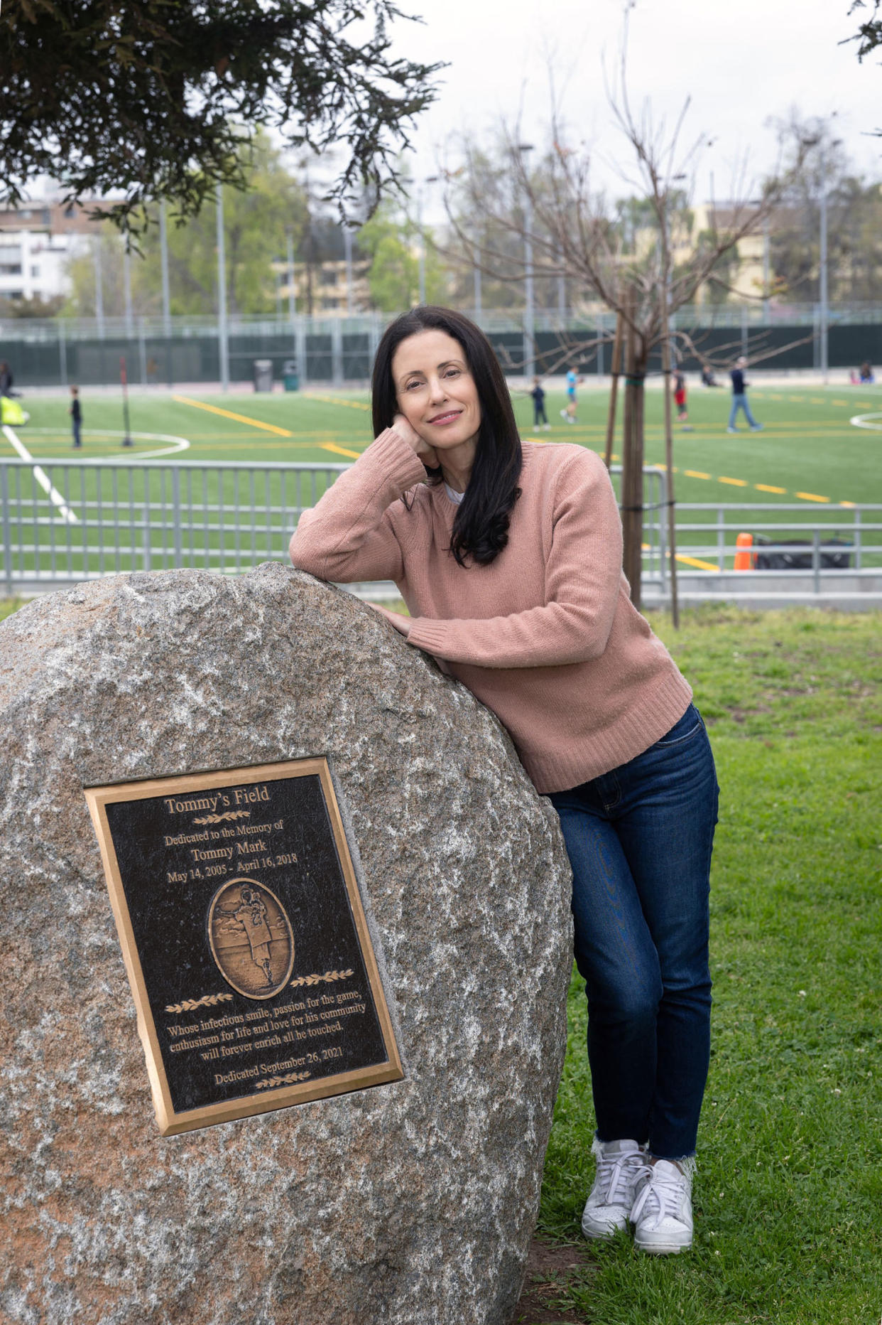 Nikki Mark posing with plaque for her son, Tommy. (Courtesy Christine Bjerke)