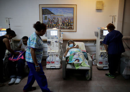 FILE PHOTO: Lesbia Avila de Molina, 53, a kidney disease patient, reacts during a dialysis session at a dialysis centre, after a blackout in Maracaibo, Venezuela, April 13, 2019. REUTERS/Ueslei Marcelino