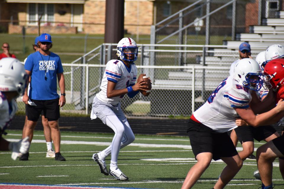 Indian Creek quarterback Arjun Lothe reads the defense as he steps back for a pass during the Braves' scrimmage at Martinsville on June 22, 2022.