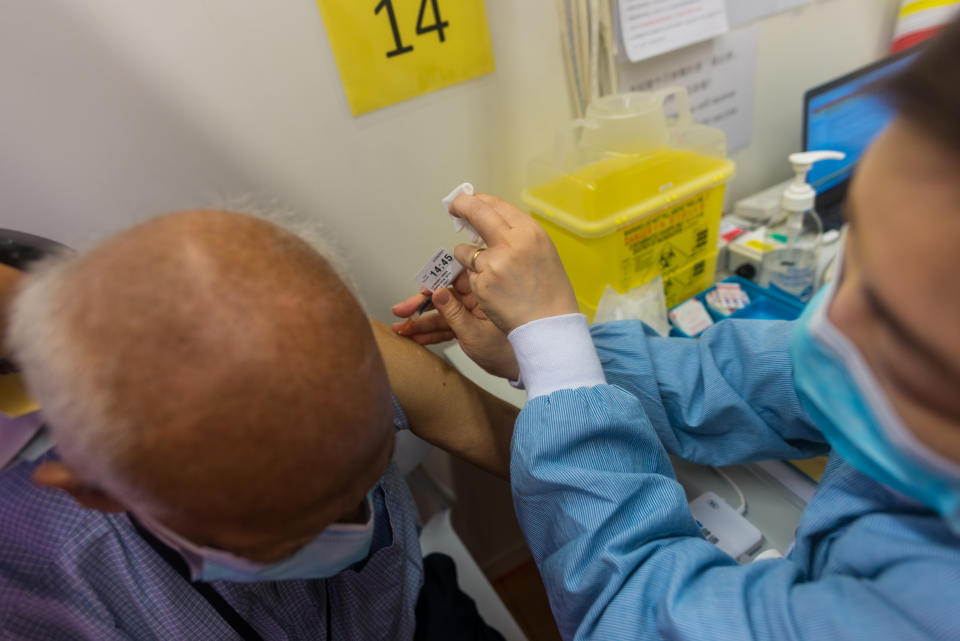 An 84-year old resident receives his second Pfizer-Biontech dose of vaccine at the Hiu Kwong vaccination center  in Hong Kong, China, on 7 Apr 2021. Originally scheduled for April 1st, his shot was rebooked to April 7th, after Hong Kong said they found packaging issues with the batches used for the first shot. After a suspension due to concerns around the packaging of batches of Pfizer-Biontech vaccines, Hong Kong resumed its vaccination program for this jab. The bookings for first and second dose far outpaced the Chinese Coronavac vaccine, beset by concerns over its safety after several deaths with cardiovascular issues happened in patients days or weeks after the jabs. The authorities have said the deaths were not linked to the Chinese vaccines. Uptake for the Pfizer-Biontech vaccine has been higher at about 15,000 bookings per day.  (Photo by Marc Fernandes/NurPhoto via Getty Images)