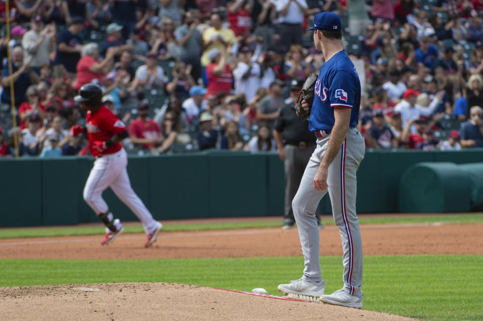 Texas Rangers starting pitcher Cody Bradford, right, watches Cleveland Guardians' Jose Ramirez round the bases after hitting a solo home run during the fourth inning of a baseball game in Cleveland, Sunday, Sept. 17, 2023. (AP Photo/Phil Long)