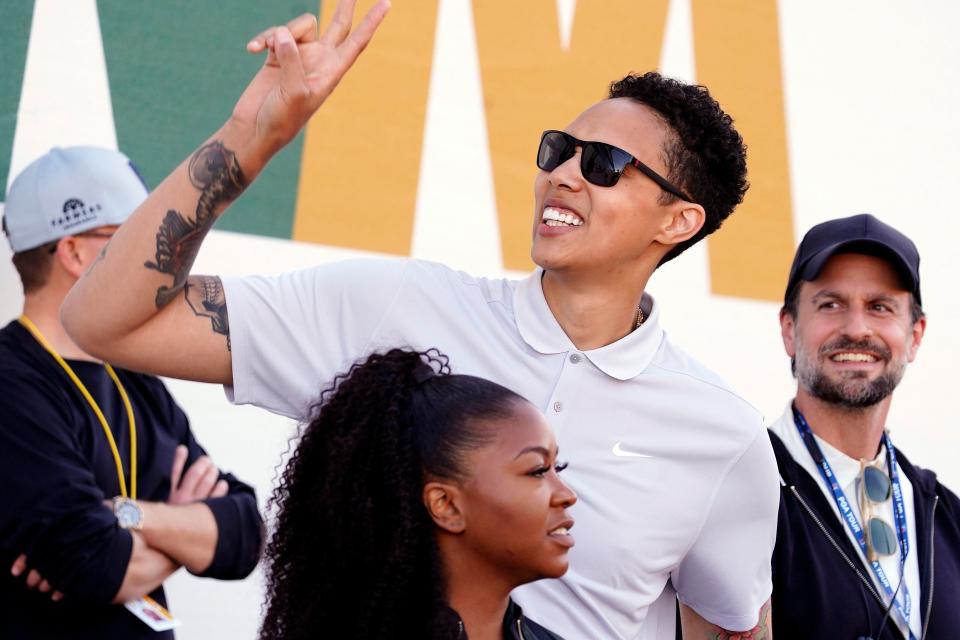 Brittney Griner acknowledges fans as she watches on the 16th hole during the third round of the Phoenix Open.