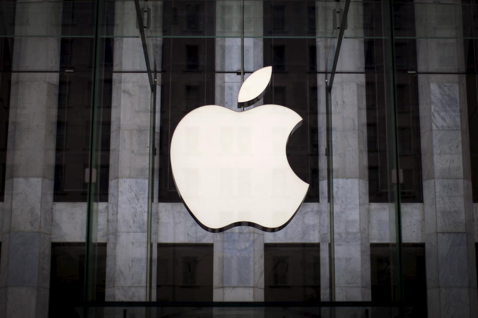 The Apple logo hangs above the entrance to the Apple Store