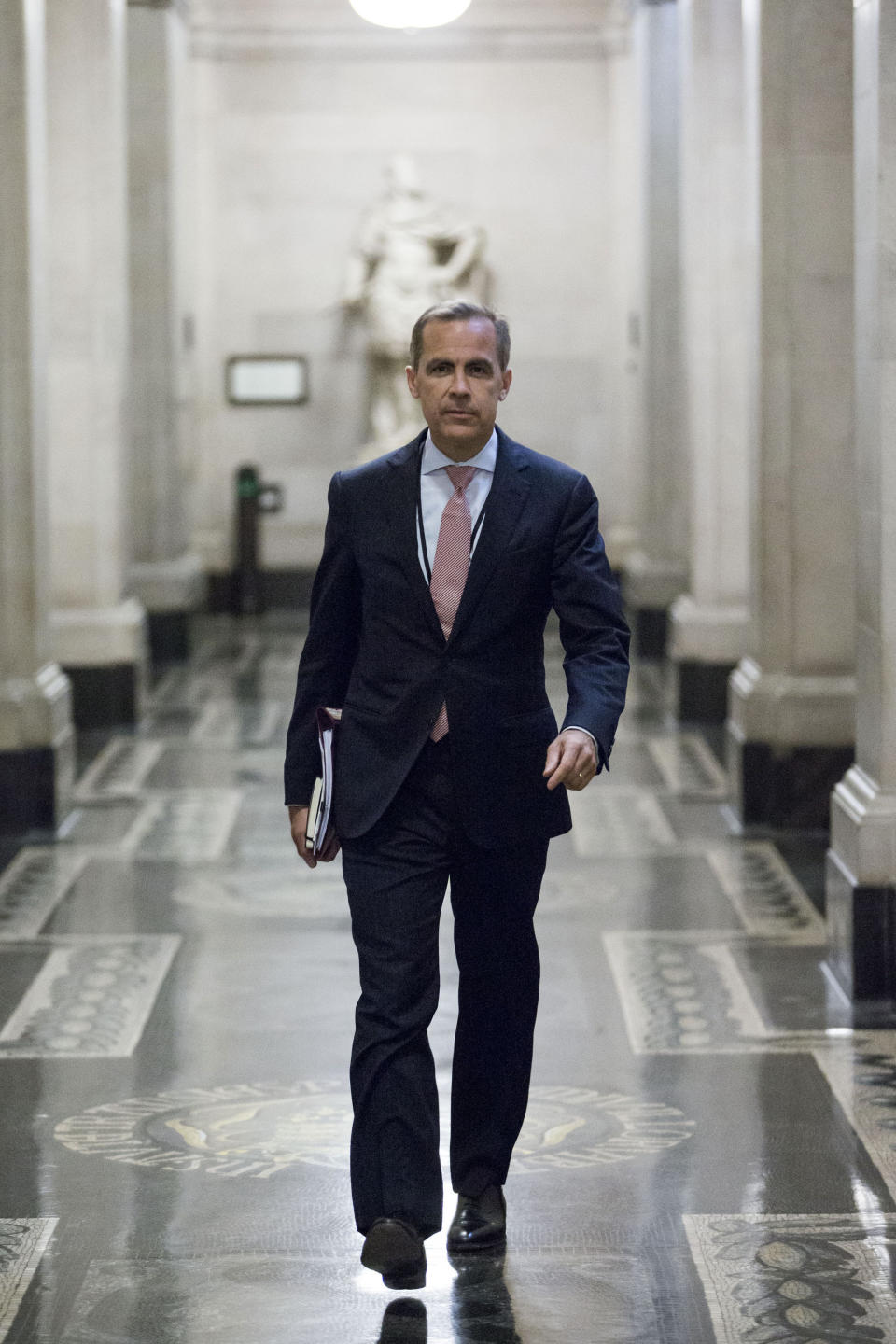 Mark Carney, governor of the Bank of England, walks to a monetary policy committee (MPC) briefing on his first day inside the central bank's headquarters in London.