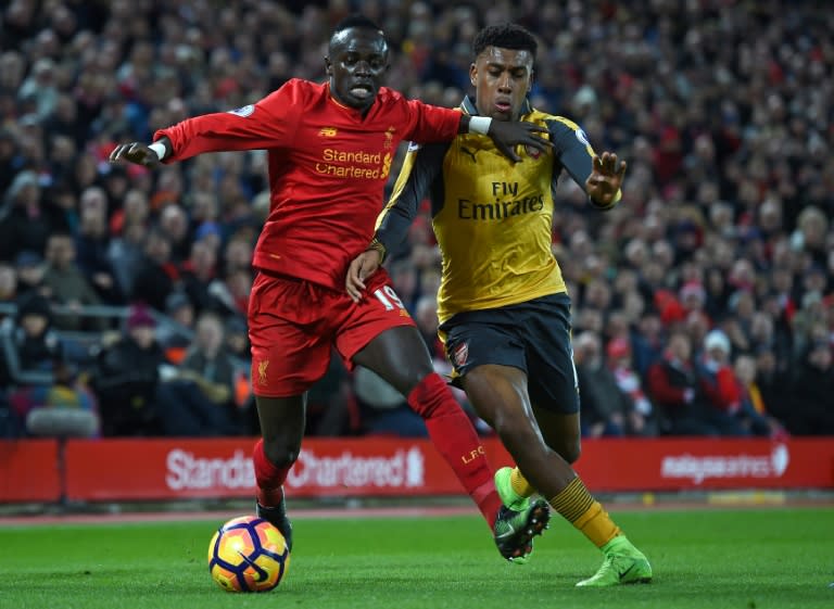 Liverpool's midfielder Sadio Mane (L) vies with Arsenal's striker Alex Iwobi during the English Premier League football match March 4, 2017