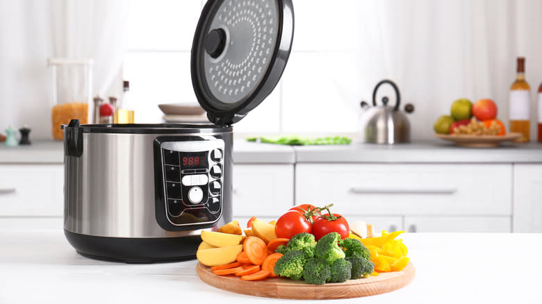 Multicooker and vegetables on kitchen counter