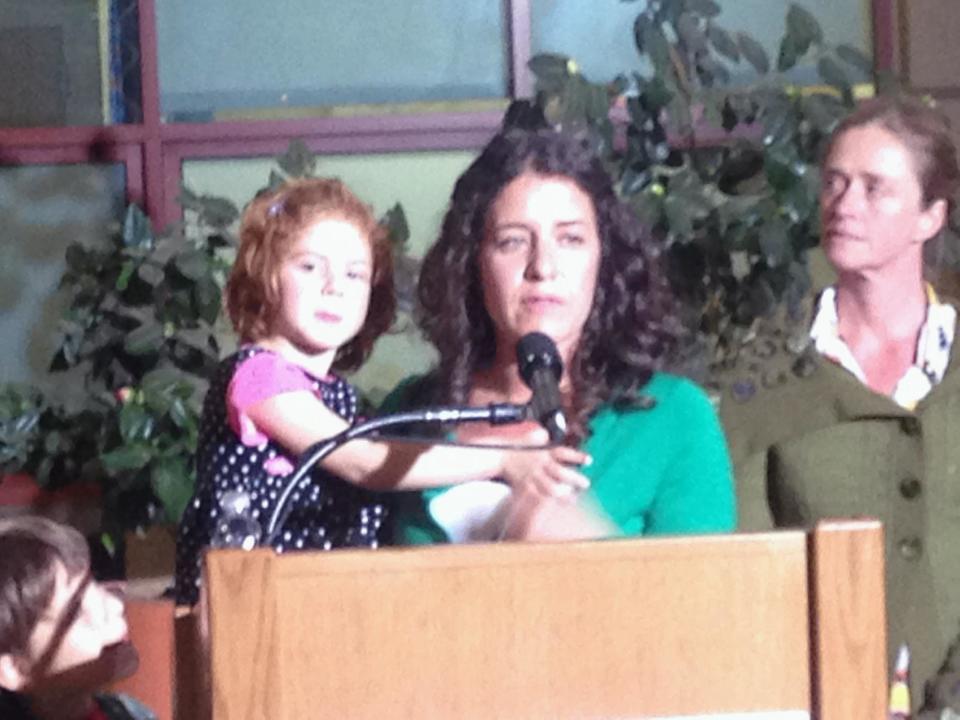 In this photo taken with a mobile phone, Jessica Tomei holds her 4-year-old daughter, Sofia Jarvis, during a news conference at Lucille Packard Children's Hospital at Stanford University on Monday, Feb. 24, 2014, in Palo Alto, Calif. Sofia is one of a handful of California children who has been diagnosed with a rare polio-like syndrome that has left her arm paralyzed. Stanford researchers say there is a possibility of an emerging infectious polio-like syndrome in California. (AP Photo/Martha Mendoza)