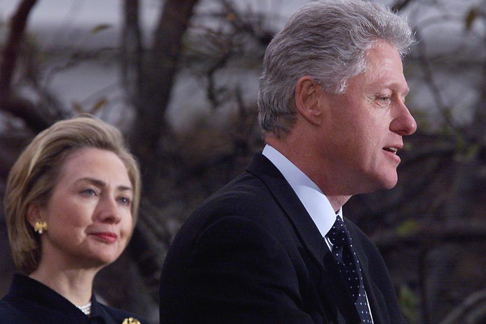 President Bill Clinton, with first lady Hillary Clinton, makes a statement to reporters following his impeachment by the House. (Photo: Tim Sloan/AFP via Getty Images)