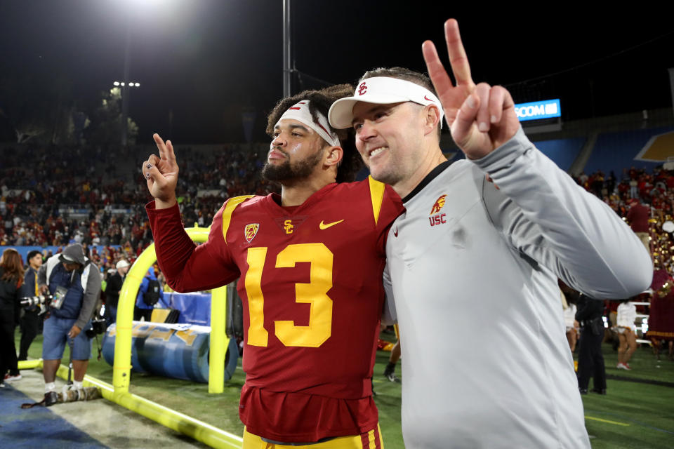 PASADENA, CA - NOVEMBER 19: USC Trojans quarterback Caleb Williams (13) and head coach Lincoln Riley (right) celebrate a victory against the UCLA Bruins after a college football game between the UCLA Bruins and the USC Trojans on November 19, 2022, at the Rose Bowl in Pasadena, CA. (Photo by Kiyoshi Mio/Icon Sportswire via Getty Images)