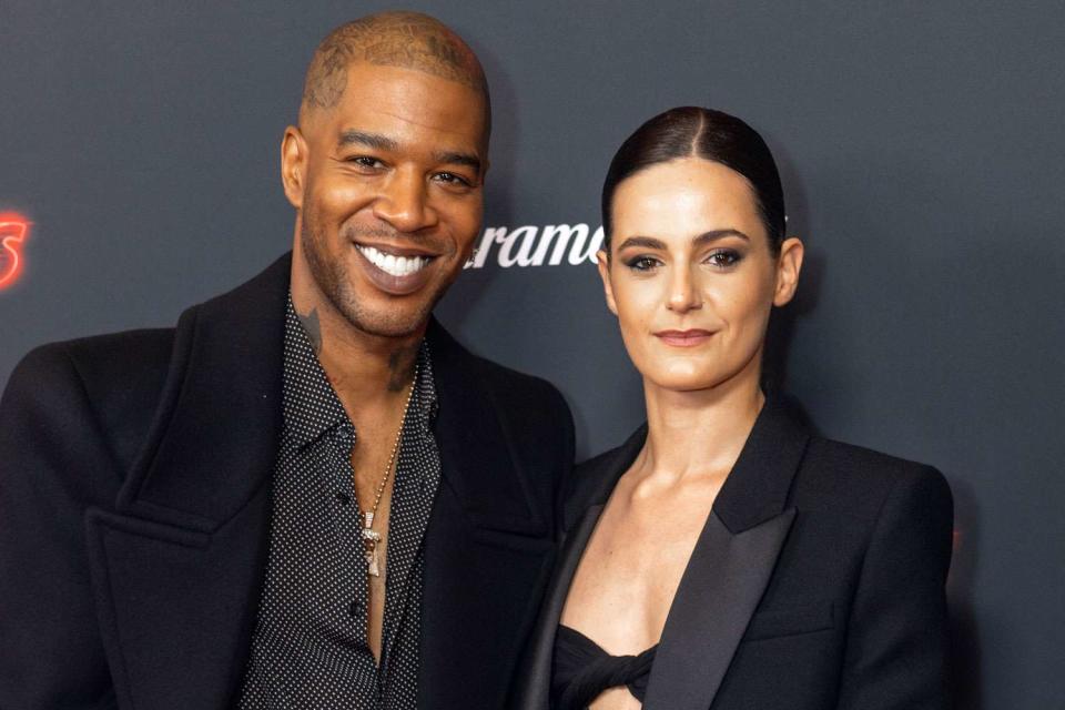 <p>Simon Ackerman/WireImage</p> From Left: Kid Cudi and Lola Abecassis Sartore in London on April 16, 2024