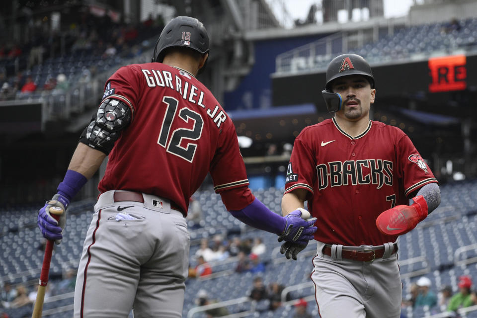 Arizona Diamondbacks' Corbin Carroll, right is greeted by Lourdes Gurriel Jr. (12) after scoring on a single by Christian Walker during the first inning of a baseball game against the Washington Nationals, Thursday, June 22, 2023, in Washington. (AP Photo/Nick Wass)