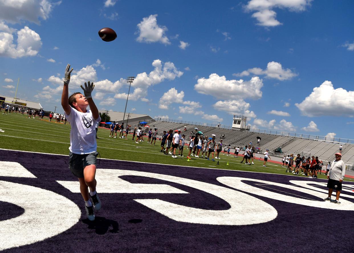 Jack Lancaster, 13, of Dallas goes deep for an end zone catch during Wednesday’s Air It Out Passing Camp at Wylie High School. Coaches from around the state and former college players instructed over 150 junior and senior high school quarterbacks and receivers in the particulars of their position.