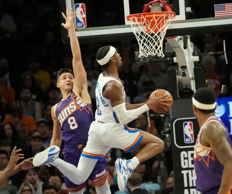 Oklahoma City Thunder guard Shai Gilgeous-Alexander (2) puts a shot up against Phoenix Suns guard Grayson Allen (8) during the third quarter at Footprint Center in Phoenix on March 3, 2024.