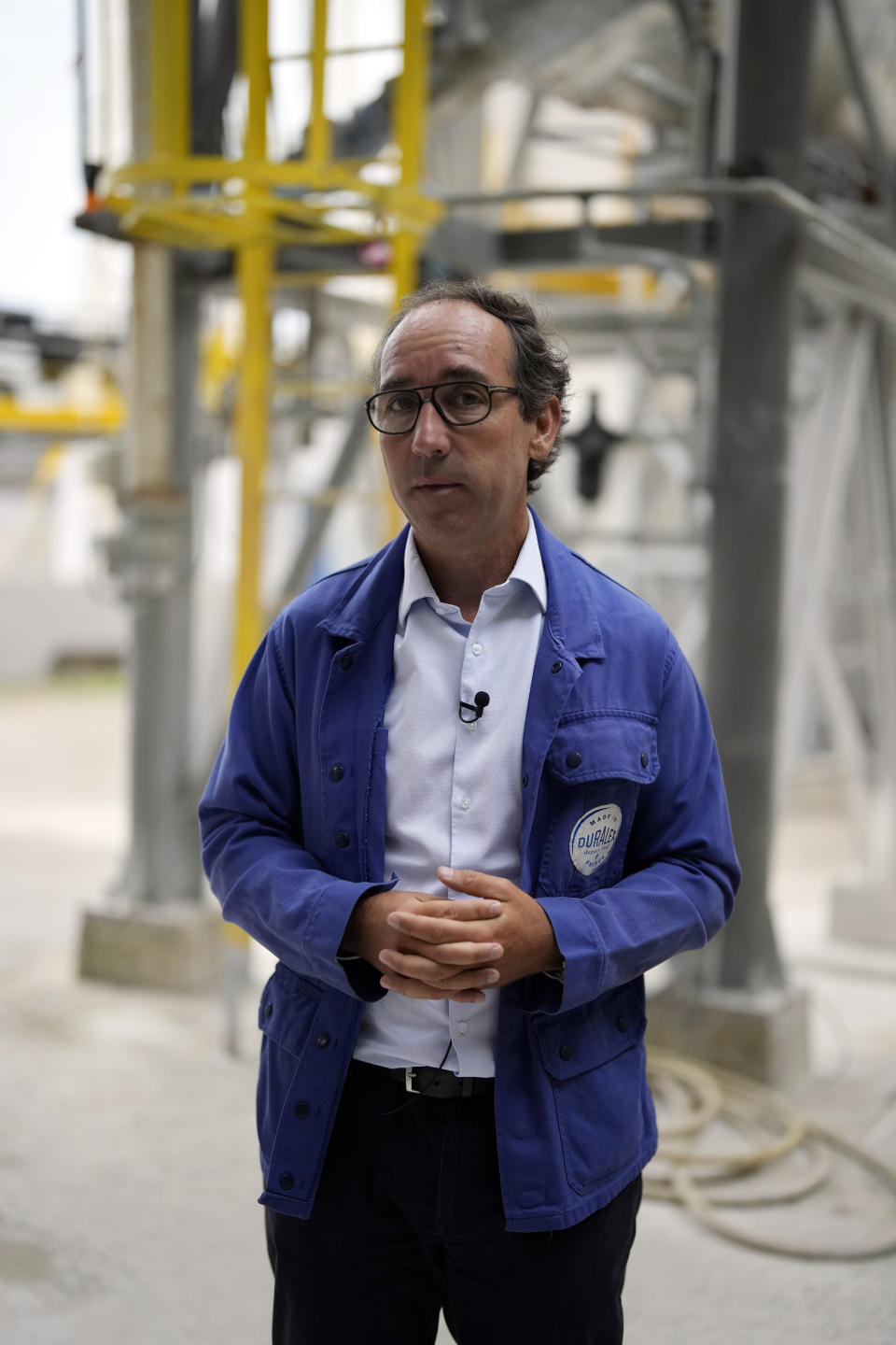 Duralex CEO, Jose Luis Llacuna, talks to The Associated Press outside the factory of the French glassmaker Duralex, in La Chapelle Saint-Mesmin, central France, Wednesday, Sept. 7, 2022. Iconic French tableware brand Duralex is joining a growing array of European firms that are reducing and halting production because of soaring energy costs. (AP Photo/Thibault Camus)