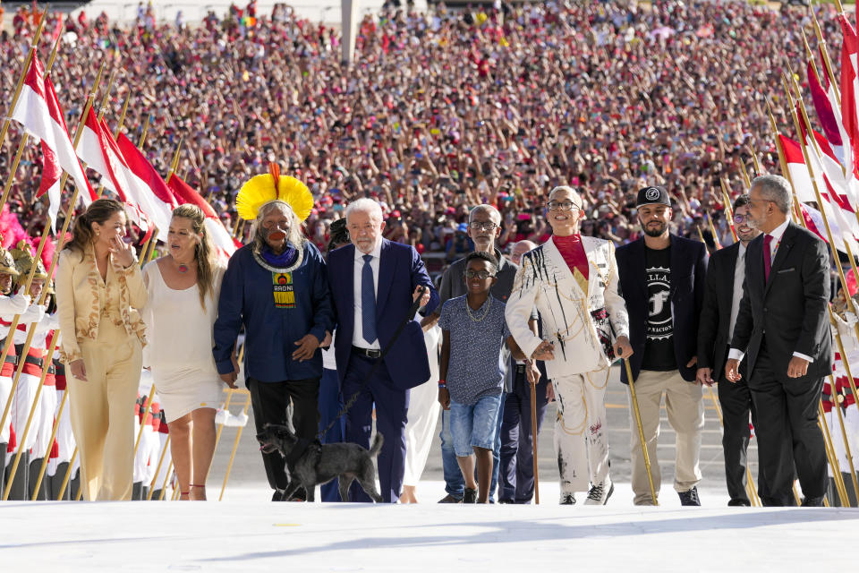 FILE - Luiz Inacio Lula da Silva arrives to the Planalto Palace with a group representing diverse segments of society after he was sworn in as president in Brasilia, Brazil, Jan. 1, 2023. Lula took office after a narrow victory over former President Jair Bolsonaro. (AP Photo/Eraldo Peres, File)